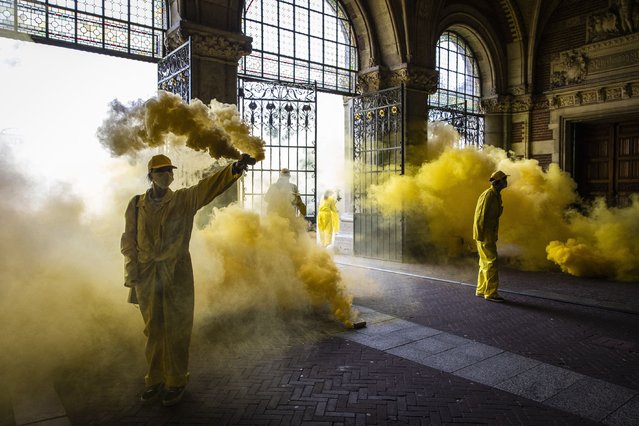 Climate activists of Extinction Rebellion, a global environmental movement, block an entrance to the Rijksmuseum in Amsterdam on September 7, 2024, to protest against the museum's main sponsor ING. (Photo by Dingena Mol/ANP via AFP Photo)