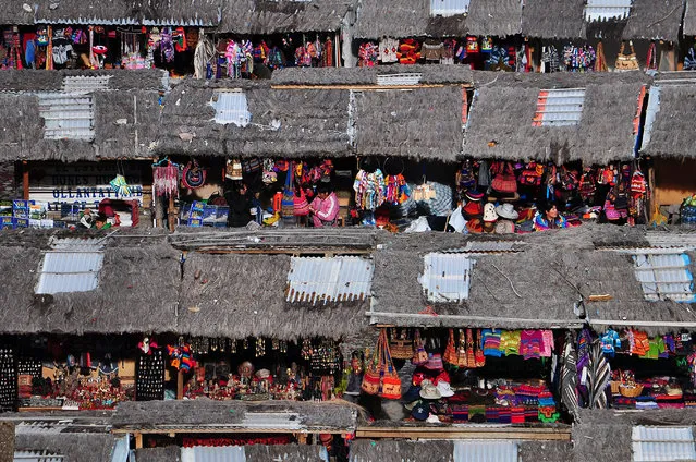 “Souvenir Market”. A small souvenir market selling wares with vibrant colors as seen from the top of the Inca remains in the town of Ollantaytambo, some 60 km from Cusco. Location: Ollantaytambo, Peru. (Photo and caption by Ben Leshchinsky/National Geographic Traveler Photo Contest)