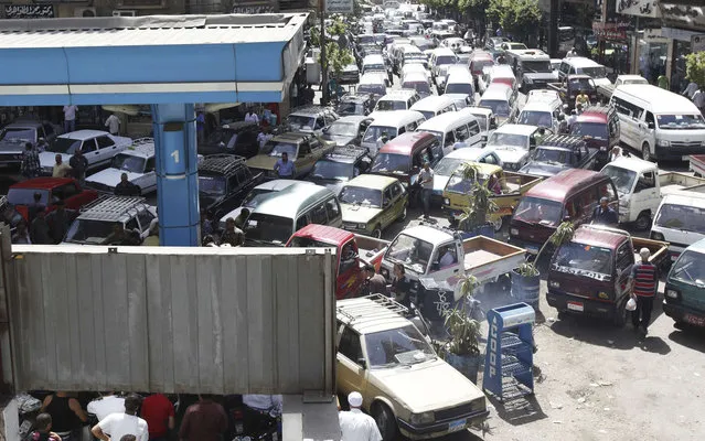 Vehicles queue at a petrol station during a fuel shortage in Cairo June 26, 2013. President Mohamed Mursi will speak to the Egyptian people on Wednesday in a televised address that could determine his political survival as millions prepare to rally to demand his removal this weekend. Fears of a showdown in the streets between Mursi's Islamist supporters and a broad coalition of the disaffected have led people to stock up on food and buy up fuel supplies. (Photo by Mohamed Abd El Ghany/Reuters)