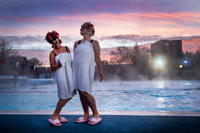 Swimmers known as the Lido Ladies pose by the pool during sunrise at Charlton Lido in Hornfair Park, London on December 2, 2020, on its first day of reopening after the second national lockdown ended and England enters a strengthened tiered system of regional coronavirus restrictions. (Photo by Victoria Jones/PA Images via Getty Images)