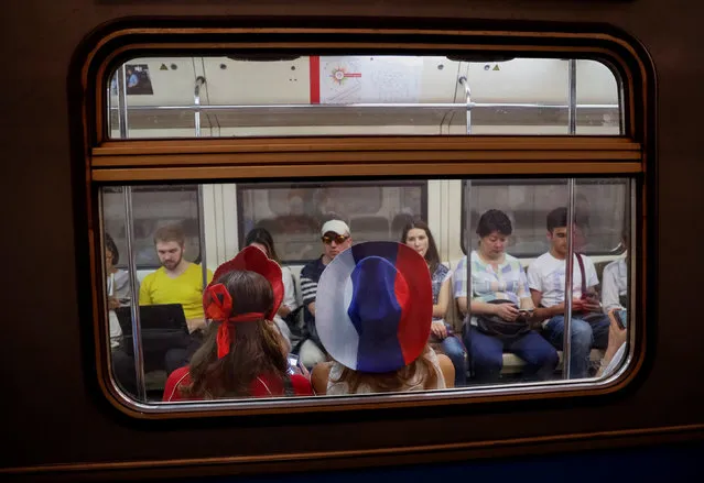 People ride metro after the World Cup final soccer match in Moscow, Russia July 15, 2018. As well as shooting all the matches, Reuters photographers are producing pictures showing their own quirky view from the sidelines of the World Cup. (Photo by Gleb Garanich/Reuters)