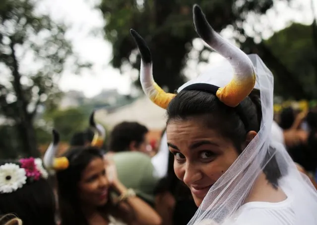 A reveller smiles as she takes part in the annual carnival block party known as “Casas comigo” or “Marry me” at the Vila Madalena neighborhood  in Sao Paulo February 1, 2015. (Photo by Nacho Doce/Reuters)