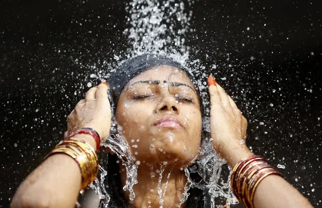 A Hindu devotee takes a ritual shower before starting her pilgrimage to the Batu Caves temple during Thaipusam in Kuala Lumpur February 3, 2015. (Photo by Olivia Harris/Reuters)