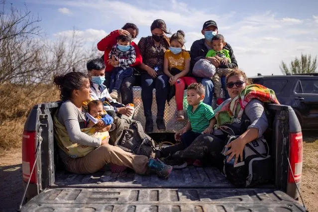 Migrant families and children sit in the back of a police truck for transport after they crossed the Rio Grande River into the United States from Mexico in Penitas, Texas, U.S., March 5, 2021. (Photo by Adrees Latif/Reuters)