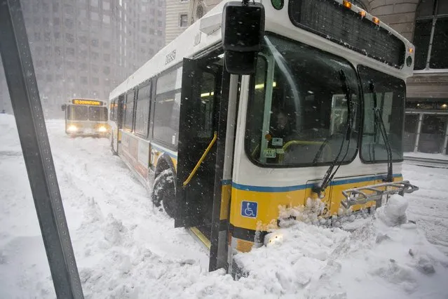 A MBTA bus sits stuck in a snowbank during a snow storm in Boston, Massachusetts February 2, 2015. Boston, already buried under two feet (60 cm) of snow from a blizzard last week, was predicted to see a foot of snow after a huge winter storm hit the northeastern United States on Monday, the region's second snowy blast in less than a week. (Photo by Dominick Reuter/Reuters)