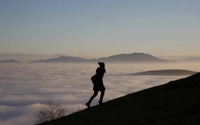 A woman walks on the Smetovi mountain range near Zenica, Bosnia and Herzegovina, December 20, 2015. (Photo by Dado Ruvic/Reuters)