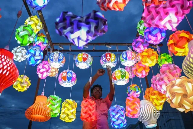 A vendor sells fancy lights along a street in Chennai on July 13, 2023. (Photo by R.Satish Babu/AFP Photo)