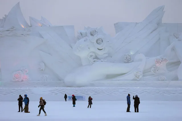 People visit a snow sculpture at the Harbin International Snow Sculpture Art Expo of the 32nd Harbin International Ice and Snow Festival, in Harbin, China's northern Heilongjiang province, 05 January 2016. (Photo by Wu Hong/EPA)