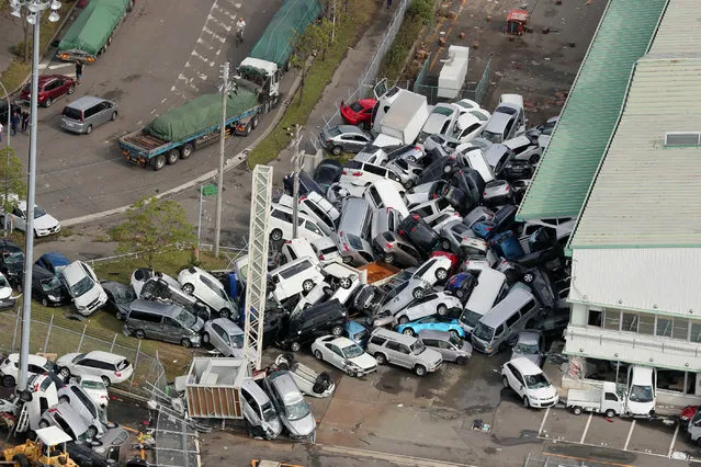 An aerial view from a Jiji Press helicopter shows vehicles piled in a heap due to strong winds in Kobe, Hyogo prefecture on September 5, 2018, after typhoon Jebi hit the west coast of Japan. The toll in the most powerful typhoon to hit Japan in a quarter century rose on September 5 to nine, with thousands stranded at a major airport because of storm damage. (Photo by AFP Photo/JIJI Press)