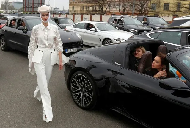 A model presents an outfit at a drive-in fashion show during the Prague Fashion Week, amid the coronavirus disease (COVID-19) outbreak, in Prague, Czech Republic, May 1, 2021. (Photo by David W. Cerny/Reuters)