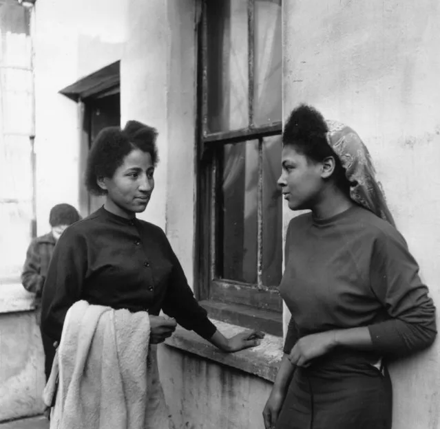 Two young women in Bute Town, one of the poorest areas of Cardiff, 23rd January 1954. The area has a lively ethnic mix of families with Arab, Somali, West African, West Indian, Egyptian, Greek and many other origins. (Photo by Bert Hardy/Picture Post/Getty Images)