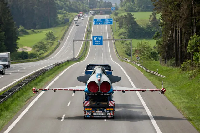 Damaged jet fighter of type Eurofighter is transported on the platform of a truck on German highway number nine near Plech, southern Germany, on May 28, 2015.  The jet fighter has been transported to a factory in Manching, southern Germany, after beeing damaged during a collision with a civil airplane in June 2014. (Photo by Daniel Karmann/AFP Photo/DPA)