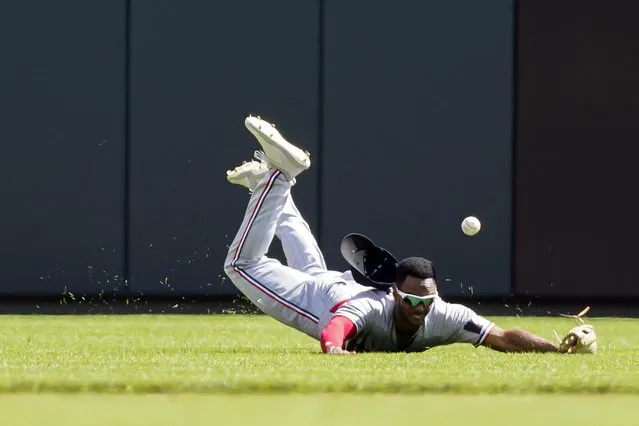 Minnesota Twins center fielder Michael A. Taylor misses a line drive hit by Cincinnati Reds' Luke Maile during the seventh inning of a baseball game, Wednesday, September 20, 2023, in Cincinnati. (Photo by Joshua A. Bickel/AP Photo)
