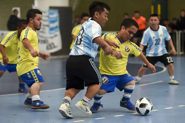 Colombia' s Juan David Traslavina (R) vies for the ball with Argentina' s Facundo Rojas during a Dwarf Copa America football match at Ferro Carril Oeste Club in Buenos Aires, on October 25, 2018. A Copa America tournament for short size men started Thursday in Argentina, aimed at stimulating integration and overcoming prejudices, and supported by Argentine football star Lionel Messi. (Photo by Eitan Abramovich/AFP Photo)