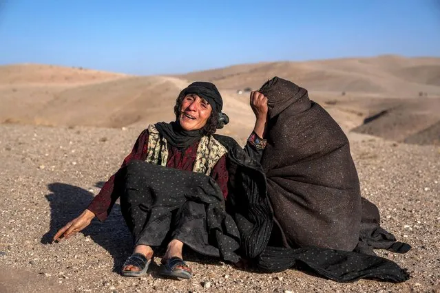 Afghan women mourn relatives killed in an earthquake at a burial site after an earthquake in Zenda Jan district in Herat province, western of Afghanistan, Sunday, October 8, 2023. (Photo by Ebrahim Noroozi/AP Photo)