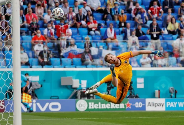 Finland's goalkeeper Lucas Hradecky concedes the opening goal goal shot by Russia's forward Aleksey Miranchuk (not pictured) during the UEFA EURO 2020 Group B football match between Finland and Russia at the Saint Petersburg Stadium in Saint Petersburg on June 16, 2021. (Photo by Evgenia Novozhenina/Reuters)