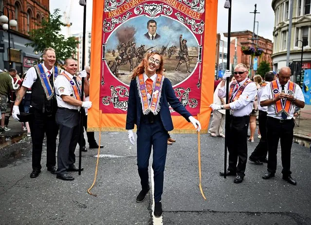 Orange Lodge members pose during a break as the annual Twelfth of July march takes place on July 12, 2021 in Belfast, Northern Ireland. The Twelfth of July marches are a protestant celebration of King William of Oranges victory over the catholic King James at the Battle of the Boyne in 1690. (Photo by Charles McQuillan/Getty Images)