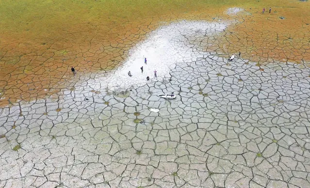 This photo taken by a drone and released by Nantou County Government, shows the dried lakebed of Sun Moon Lake in Nantou county in central Taiwan on April 23, 2021. Some households in Taiwan are going without running water two days a week after a months-long drought dried up the island's reservoirs and a popular tourist lake. (Photo by Nantou County Government via AP Photo)