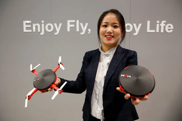 Eve Bu of Mola shows off the UFO, a drone that folds into a compact size for easy transport, during the 2017 CES in Las Vegas, Nevada, U.S., January 6, 2017. The drone is expected to be available in Spring 2017 and retail for $399.00, she said. (Photo by Steve Marcus/Reuters)