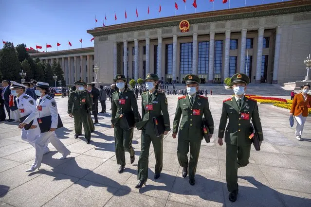 Military attendees leave after the opening ceremony of the 20th National Congress of China's ruling Communist Party at the Great Hall of the People in Beijing, Sunday, October 16, 2022. Chinese leader Xi Jinping signaled Sunday that his government would maintain policies that have put it at odds with the U.S. and other nations and deepened Communist Party control of the economy and society. (Photo by Mark Schiefelbein/AP Photo)