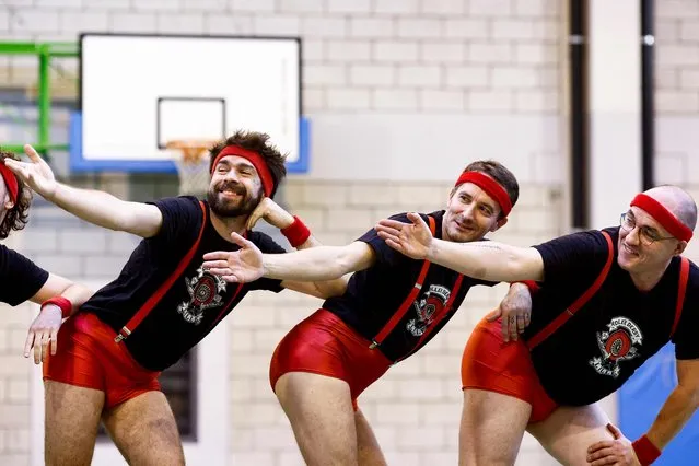 Members of the French men's cheerleading squad “Scrimmage People”, a male-only roller derby pom-pom boys team, perform during their show at the Omnisports stadium in Amay on November 13, 2022. The Scrimmage People, one of the first cheerleading groups in France, made up of teachers, salesmen, early childhood educators and programmers, was launched in 2016 within the Lille roller derby club, after a series of training sessions alongside pioneers of the genre, the Fearleaders, an Austrian cheerleading group. (Photo by Kenzo Tribouillard/AFP Photo)