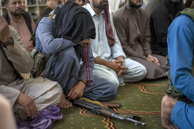A member of the Taliban prays inside a mosque during Friday prayers in Kabul, Afghanistan, Friday, September 17, 2021. (Photo by Bernat Armangue/AP Photo)
