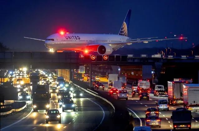 A United aircraft rolls over the highway to its parking position after landing at the airport in Frankfurt, Germany, Thursday, February 15, 2024. (Photo by Michael Probst/AP Photo)
