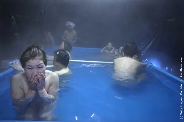 Japanese earthquake victims enjoy a communal bath set up in tents by the Japanese Self Defense Force
