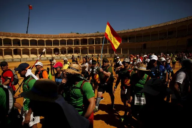 Runners cross a bullring as they participates in the XVIII 101km international competition in Ronda, southern Spain, May 9, 2015. (Photo by Jon Nazca/Reuters)