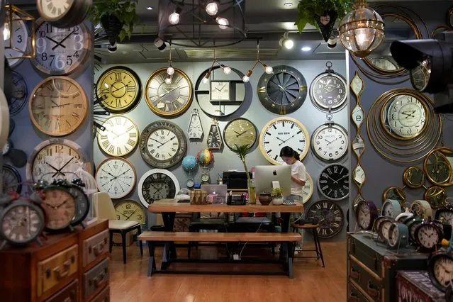 A staff member stands in a stall that sells clocks at the Yiwu Wholesale Market in Yiwu, Zhejiang province, China, May 10, 2019. (Photo by Aly Song/Reuters)