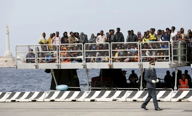 Migrants wait to disembark from the Migrant Offshore Aid Station (MOAS) ship MV Phoenix in the Sicilian harbour of Messina, Italy May 16, 2015. (Photo by Antonio Parrinello/Reuters)