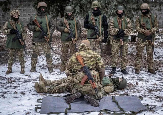Volunteers who aspire to join the 3rd Separate Assault Brigade of the Ukrainian Armed Forces listen to an instructor during basic training at an undisclosed location in the Kyiv region, Ukraine on January 9, 2024. (Photo by Viacheslav Ratynskyi/Reuters)