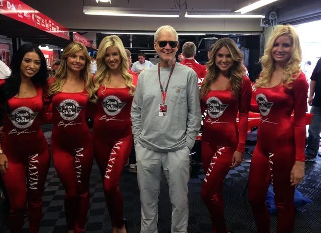 David Letterman, who ended his 33-year career as a late-night television host Wednesday, poses with models before the start of the Indianapolis 500 on Sunday, May 24, 2015, at the Indianapolis Motor Speedway in Indianapolis. Letterman's IndyCar team paid tribute to the former “Late Show” host by putting a caricature of his face and (hash)thanksdave on driver Oriol Servia's yellow car for Sunday's race. (Photo by Dan Gelston/AP Photo)