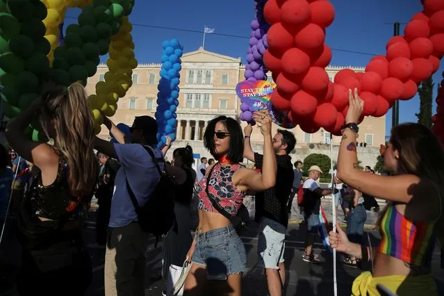 Participants take part in the Gay Pride parade outside parliament building in Athens, Greece on June 8, 2019. (Photo by Costas Baltas/Reuters)