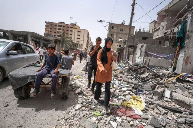 Palestinians inspect the damage to a building in the city of Nuseirat in the central Gaza Strip on April 18, 2024, amid ongoing battles between Israel and the militant Hamas group. (Photo by AFP Photo/Stringer)