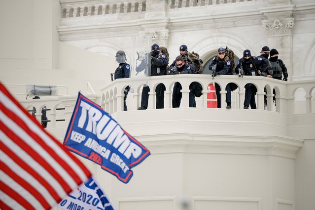Police keep a watch on demonstrators who tried to break through a police barrier, Wednesday, January 6, 2021, at the Capitol in Washington. (Photo by Joel Marklund/Imago)
