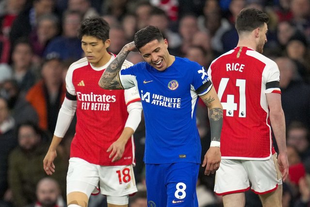 Chelsea's Enzo Fernandez, center, reacts after Arsenal's Leandro Trossard scoring his side's opening goal during the English Premier League soccer match between Arsenal and Chelsea at Emirates Stadium in London, Tuesday, April 23, 2024. (Photo by Kin Cheung/AP Photo)