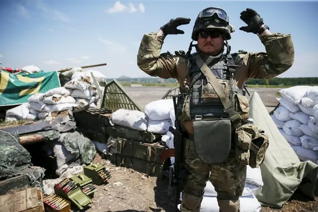 A member of the Ukrainian armed forces is seen near the town of Maryinka, eastern Ukraine, June 5, 2015. Ukraine's president told his military on Thursday to prepare for a possible "full-scale invasion" by Russia all along their joint border, a day after the worst fighting with Russian-backed separatists in months.  REUTERS/Gleb Garanich