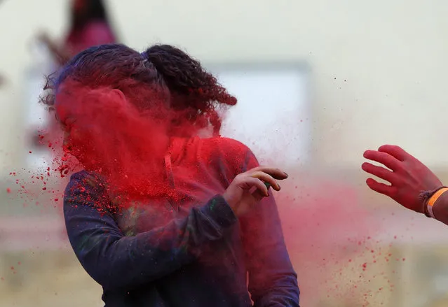 A participant reacts as she gets hit in the face with coloured powder during the Holi Festival of Colours organised by the Maltese Indian community in Qormi, outside Valletta, March 30, 2014. The Holi festival, marking the passing of winter to spring, was delayed by a few days to avoid clashing with students' examinations, according to organisers. (Photo by Darrin Zammit Lupi/Reuters)