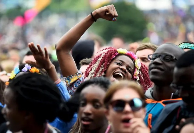 Revellers dance as singer Mary J. Blige performs on the Pyramid stage at Worthy Farm in Somerset during the Glastonbury Festival in Britain, June 26, 2015. (Photo by Dylan Martinez/Reuters)