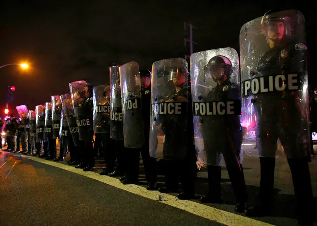 Police in riot gear arrive to break-up a demonstration outside Republican U.S. presidential candidate Donald Trump's campaign rally in Costa Mesa, California, April 28, 2016. (Photo by Mike Blake/Reuters)