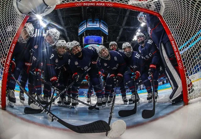 Players of the USA pose for a team photo prior to the women's play-offs semifinal match of the Beijing 2022 Winter Olympic Games ice hockey competition between USA and Finland, at the Wukesong Sports Centre in Beijing on February 14, 2022. (Photo by Brian Snyder/AFP Photo)