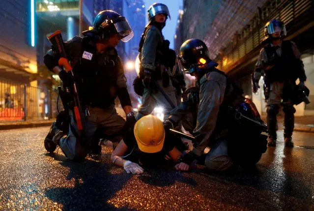 Riot police detain a demonstrator during a protest in Tsuen Wan, in Hong Kong, China on August 25, 2019. (Photo by Thomas Peter/Reuters)