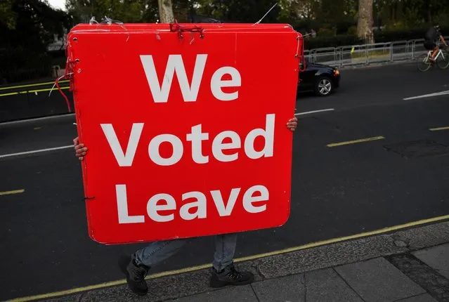 A pro-Brexit protester carries signs outside the Houses of Parliament in London, Britain, September 4, 2019. (Photo by Dylan Martinez/Reuters)