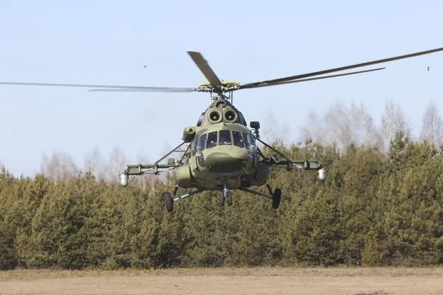 A Belarusian military helicopter with the Ukrainian delegation on the board lands in Gomel region, Belarus, Monday, February 28, 2022. The Russian and Ukrainian delegations met for their first talks Monday. The meeting is taking place in Gomel region on the banks of the Pripyat River. (Photo by Sergei Kholodilin/BelTA Pool Photo via AP Photo)