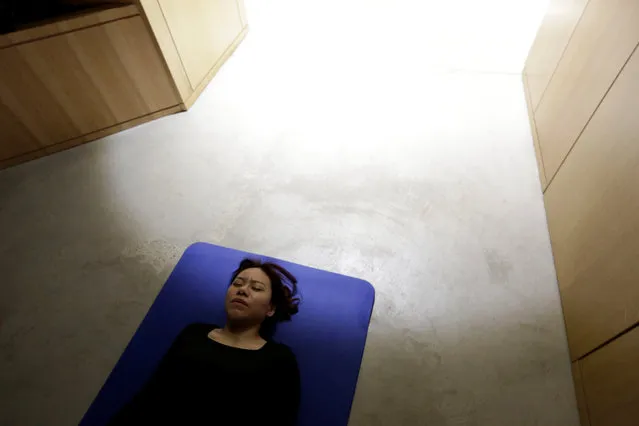 Zhang Kun, an employee at BaishanCloud, practices Yoga before lunch at the office in Beijing, China, April 26, 2016. (Photo by Jason Lee/Reuters)