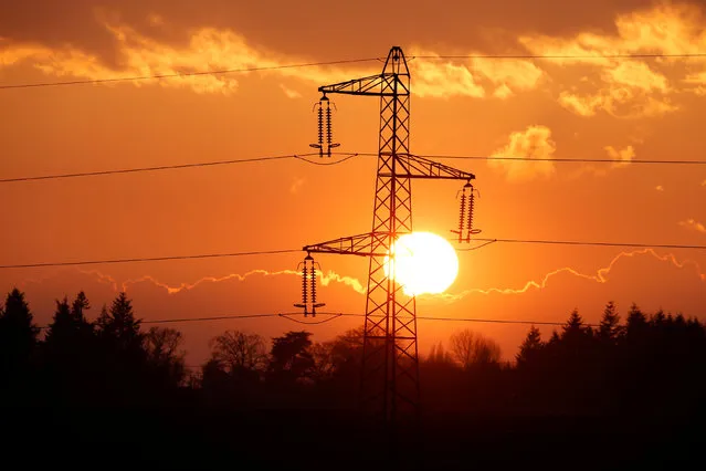 Electrical power pylons of high-tension electricity power lines are seen at sunset in Cambligneul near Arras, France, February 15, 2017. (Photo by Pascal Rossignol/Reuters)