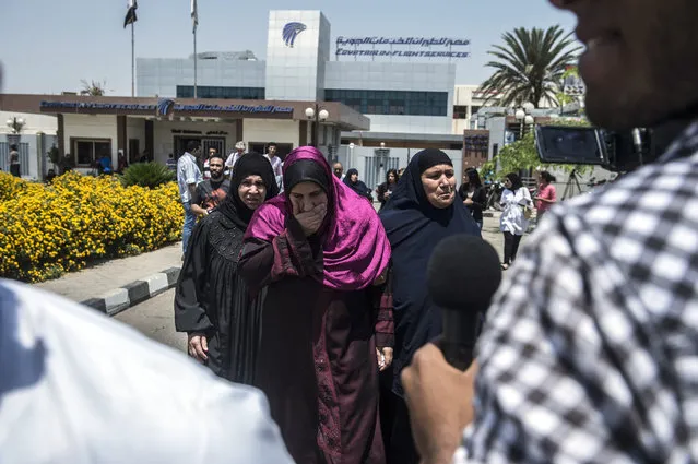 Family members of passengers who were flying aboard an EgyptAir plane that vanished from radar en route from Paris to Cairo overnight get ready to be transported by bus to a gathering point at Cairo airport on May 19, 2016. The EgyptAir flight that vanished over the Mediterranean was carrying 30 Egyptian and 15 French passengers, as well as a Briton and a Canadian, the airline said. (Photo by Khaled Desouki/AFP Photo)