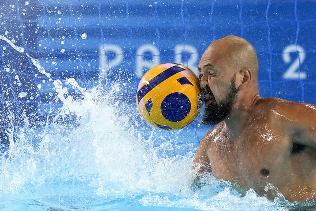 Japan's Katsuyuki Tanamura reaches for a shot during a Japan men's water polo team training session at the Olympic Aquatics Centre, ahead of the 2024 Summer Olympics, Tuesday, July 23, 2024, in Saint-Denis, France. (Photo by Luca Bruno/AP Photo)