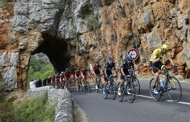 Team Sky rider Chris Froome of Britain (R), the overall leader's yellow jersey holder, cycles in the Gorges du Tarn during the 178.5-km (110.9 miles) 14th stage of the 102nd Tour de France cycling race from Rodez to Mende, France, July 18, 2015. (Photo by Eric Gaillard/Reuters)